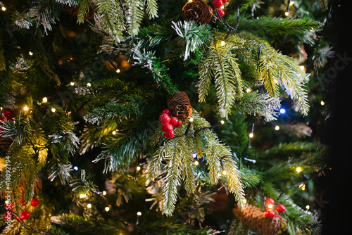 Merry Christmas and New Year holidays background. Beautiful decorated christmas tree. Beautiful decorated fireplace and Christmas tree at cottage.