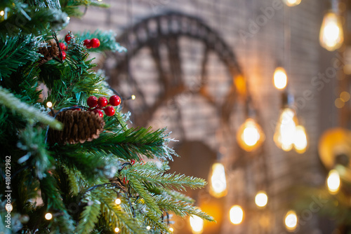 Merry Christmas and New Year holidays background. Beautiful decorated christmas tree. Beautiful decorated fireplace and Christmas tree at cottage.