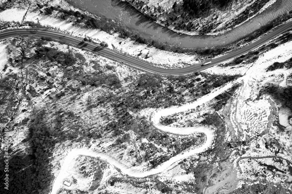 Obraz premium Aerial view on mountain road from drone in winter.