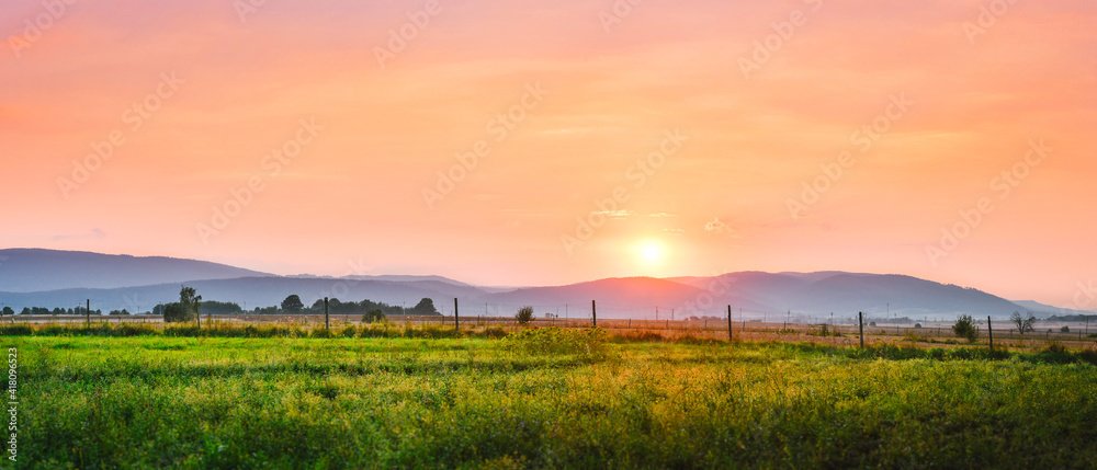 Summer orange sunset over a mountain range.