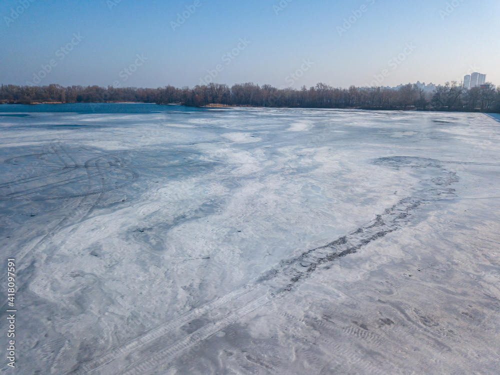 Frosty pattern on ice. Aerial drone top view. Sunny winter day. Frosty pattern on ice. Aerial drone top view. Sunny winter day.
