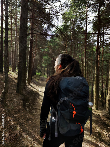 Hiker woman trekking to mountains