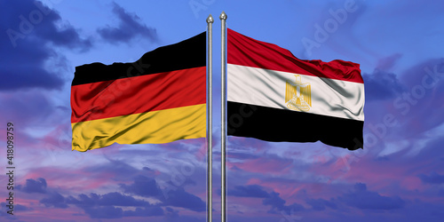 Egypt and Germany flag waving in the wind against white cloudy blue sky together. Diplomacy concept, international relations © issam