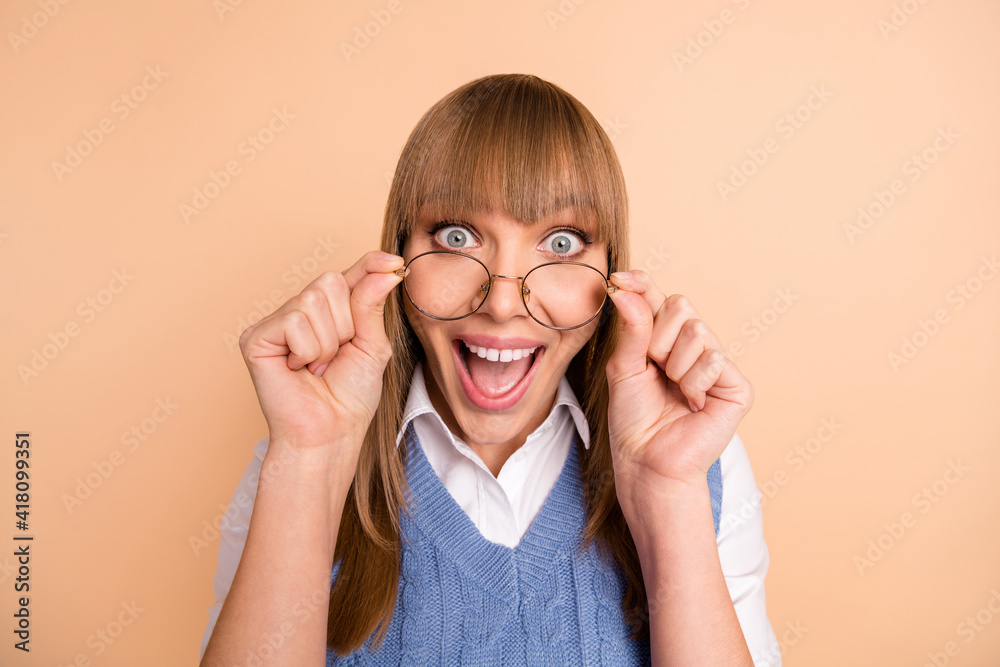 Photo portrait of female student amazed shocked taking off glasses smiling overjoyed isolated on pastel beige color background Photo portrait of female student amazed shocked taking off glasses smiling overjoyed isolated on pastel beige color background