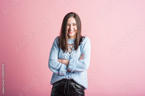 Smiling and happy brunette girl in studio on pink background © Павел Костенко