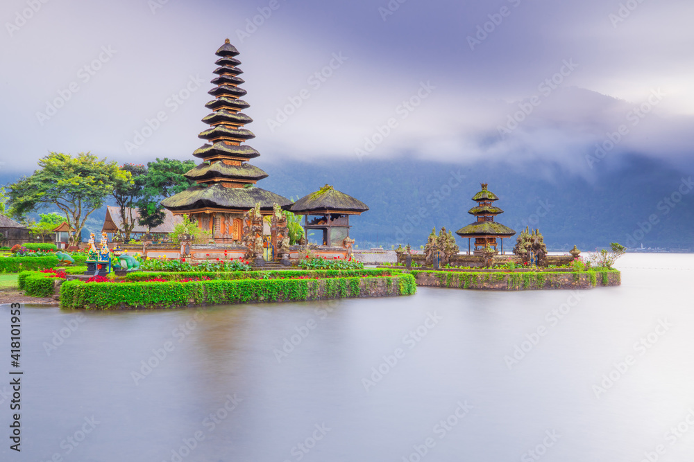 Pura Ulun Danu Bratan temple in Bali island. Beautiful balinese temple during sunrise. Balinese landmark. Cloudy sky. Water reflection. Slow shutter speed. Bratan lake, Bali Pura Ulun Danu Bratan temple in Bali island. Beautiful balinese temple during sunrise. Balinese landmark. Cloudy sky. Water reflection. Slow shutter speed. Bratan lake, Bali