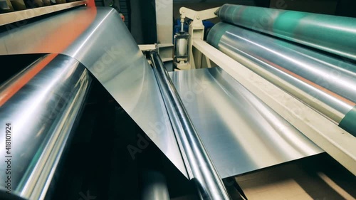 Sheet of metal material is moving through the rolling transporter