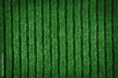 Texture of a green wool sweater with a pattern.