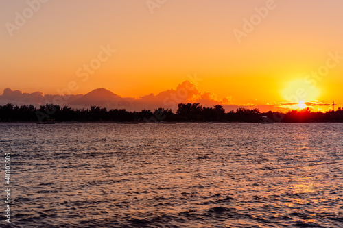 Sunset or sunrise at tropical beach with ocean on Gili island