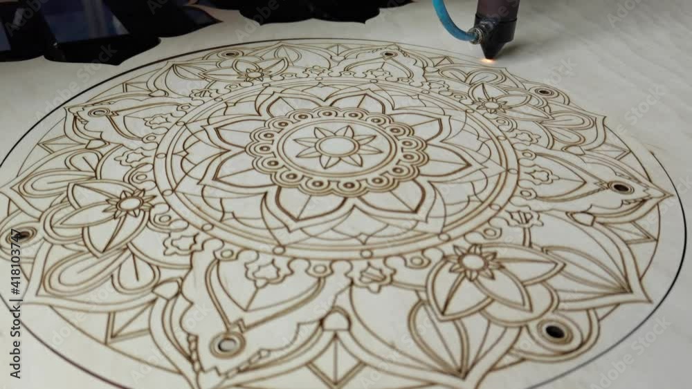 modern industrial equipment. Laser cutting on wood. The laser beam passes through the plywood, cuts out a drawing or pattern. processing wooden products. Modern technologies in woodworking