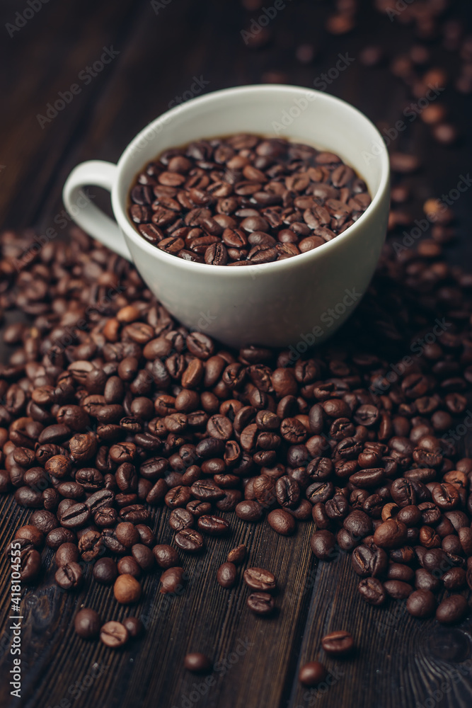 cup with coffee grains on a wooden table aromatic drink Arabica product