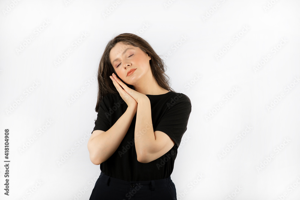 Tired young girl gesturing sleep with hands and closed her eyes Tired young girl gesturing sleep with hands and closed her eyes