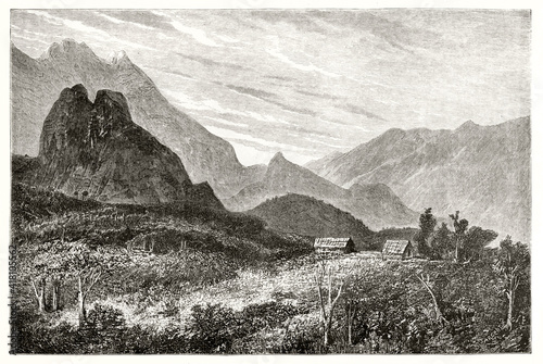 two isolated little houses surrounded by huge natural landscape in Cirque de Cilaos, Reunion island. Ancient grey tone etching style art by De Berard, Magasin Pittoresque, 1838 photo