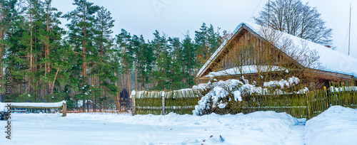 Old Typical Rural House In Winter Day. Rural life concept.