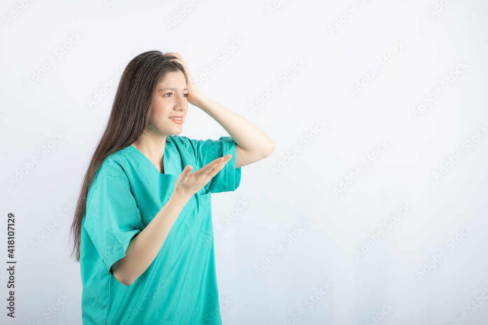 Young medical worker feeling sick and making a hand gesture Young medical worker feeling sick and making a hand gesture