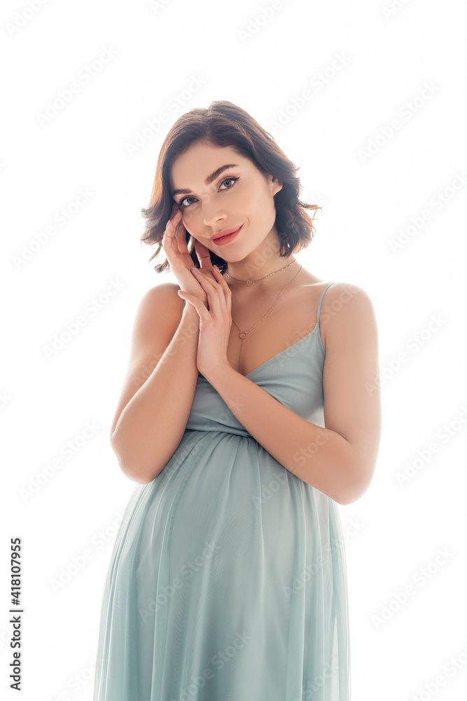 Pregnant woman in dress looking at camera isolated on white Pregnant woman in dress looking at camera isolated on white