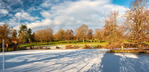 Lowndes Park in Chesham, England with completely frozen Skottowe's Pond in winter photo