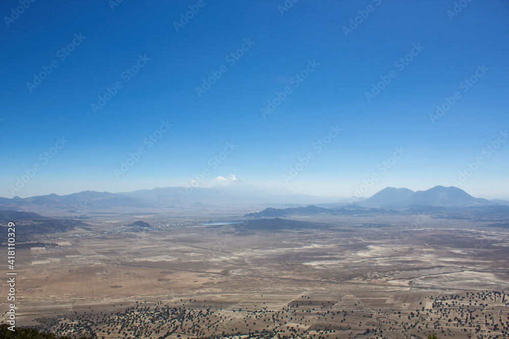 Mesmerizing view of the Pico de Orizaba stratovolcano gleaming under the blue sky in Mexico