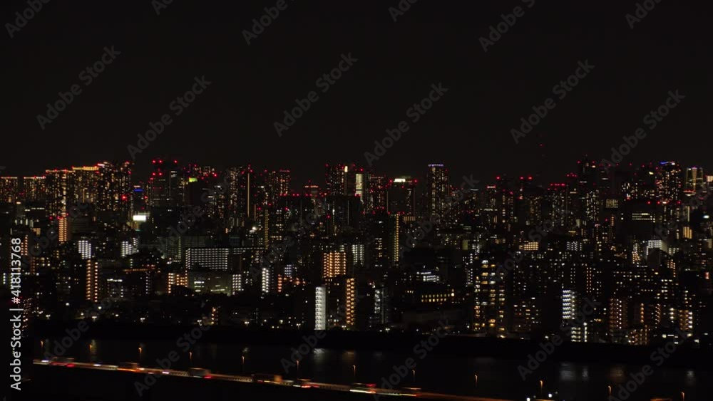 TOKYO, JAPAN : Aerial high angle view of CITYSCAPE of TOKYO at night. View of busy central downtown area (Roppongi, Minato ward). Japanese urban metropolis and nightlife concept. Time lapse shot. TOKYO, JAPAN : Aerial high angle view of CITYSCAPE of TOKYO at night. View of busy central downtown area (Roppongi, Minato ward). Japanese urban metropolis and nightlife concept. Time lapse shot.
