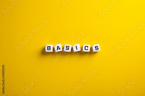 Basics word written on blocks with flat lay view. Back to basics or simplifying business concept. photo
