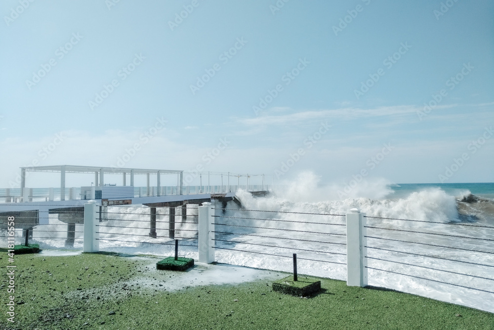 Obraz premium Waves crash on the shore. Storm into the rocky beach. Landscape of Batumi, Georgia