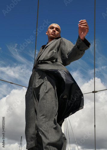 low angle view of male fashion model posing in city