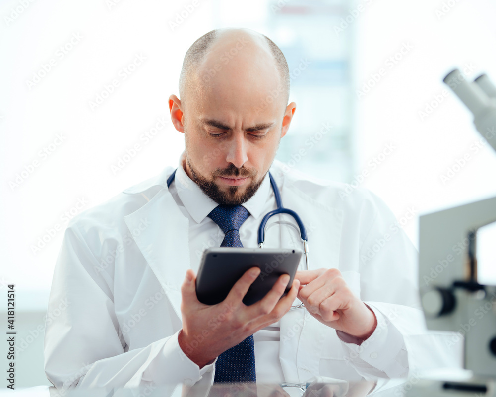 researcher with a digital tablet sitting at a lab table . researcher with a digital tablet sitting at a lab table .
