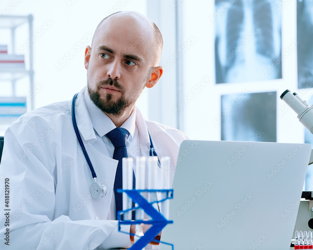 researcher works on a laptop in a medical lab. researcher works on a laptop in a medical lab.