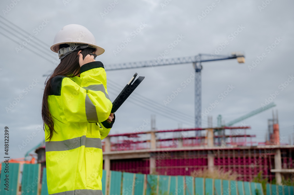 Asian engineer working at site of a large building project,Thailand people,Work overtime at construction site Asian engineer working at site of a large building project,Thailand people,Work overtime at construction site