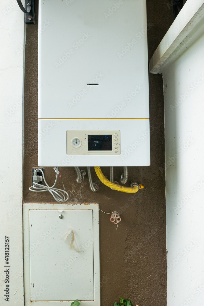 Rectangular Heater for Hot Water Connected to the Outside of the House