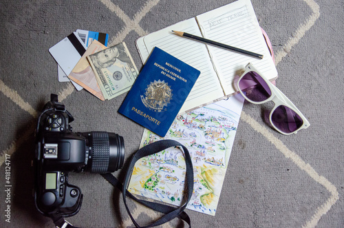 Flat lay travel objects with passports, camera, sunglass, map, money, credit cards, notebook and pencil