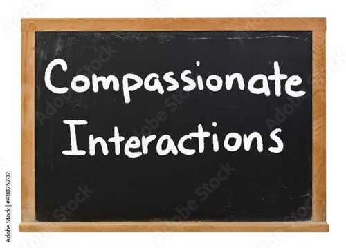 Compassionate Interactions written in white chalk on a black chalkboard