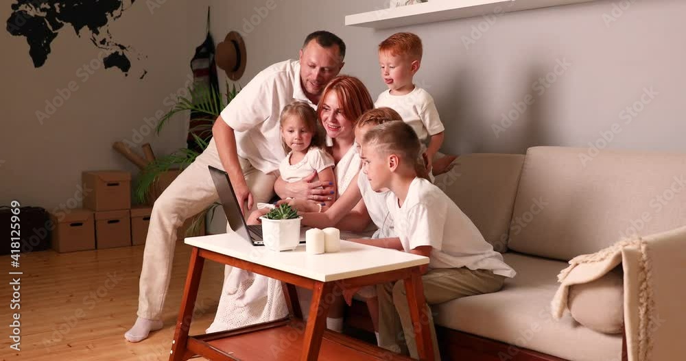family young parents couple and cute kids using laptop looking at computer screen enjoying watching funny social media video doing online shopping relaxing on sofa at home together family young parents couple and cute kids using laptop looking at computer screen enjoying watching funny social media video doing online shopping relaxing on sofa at home together