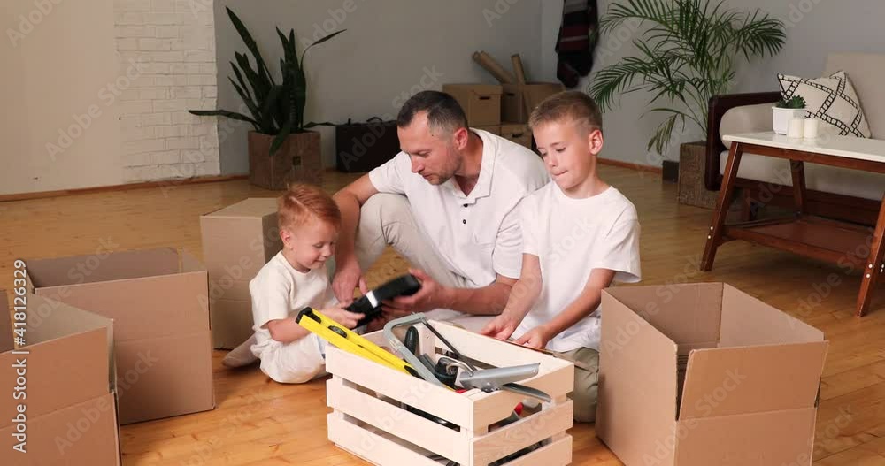 sons and father make repairs in the house. the boys help Dad. toolbox. sons and father make repairs in the house. the boys help Dad. toolbox.