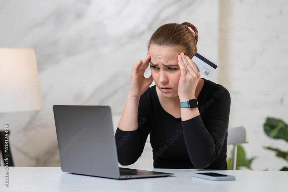 Nervous horrified confused young woman cheated girl, stressed worried lady having problem with paying, buying online payments with credit blocked bank card, looking at screen of laptop. Internet fraud Nervous horrified confused young woman cheated girl, stressed worried lady having problem with paying, buying online payments with credit blocked bank card, looking at screen of laptop. Internet fraud