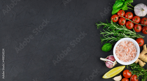 Colorful various herbs and spices for cooking on dark background, copy space, mock up, banner