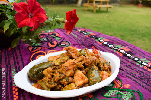 Food authenthic indiand village style gujarati dish surti undhiyu. mixed vegetable item coked with stuffed brinjal, potato, yams, methi muthiya dhokli. papdi its sweet and spicy photo