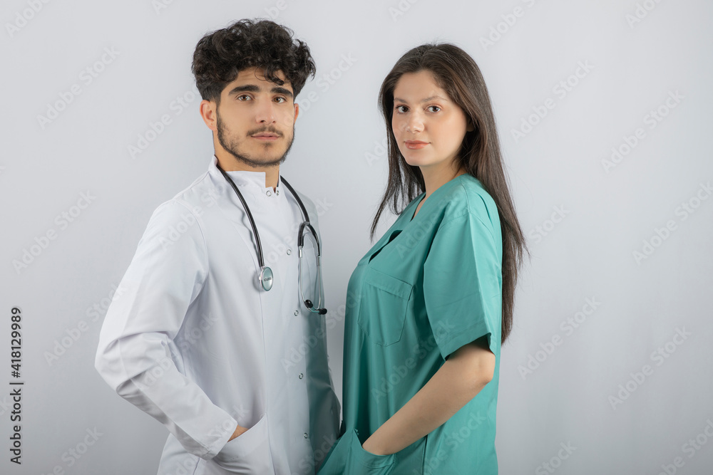 Young male doctor and female nurse looking at camera Young male doctor and female nurse looking at camera