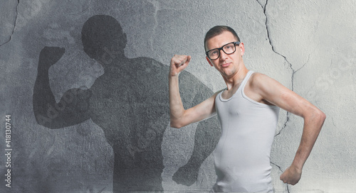 Portrait of a funny skinny bodybuilder. Humorous sportsman using small dumbbells for bodybuilding photo