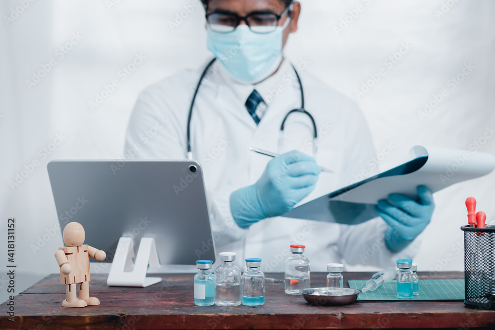 Doctors or scientists are experimenting with the science of a vaccine to treat COVID-19 with a laptop, work in a lab or hospital. The concept of doing it with new and normal technology. Doctors or scientists are experimenting with the science of a vaccine to treat COVID-19 with a laptop, work in a lab or hospital. The concept of doing it with new and normal technology.