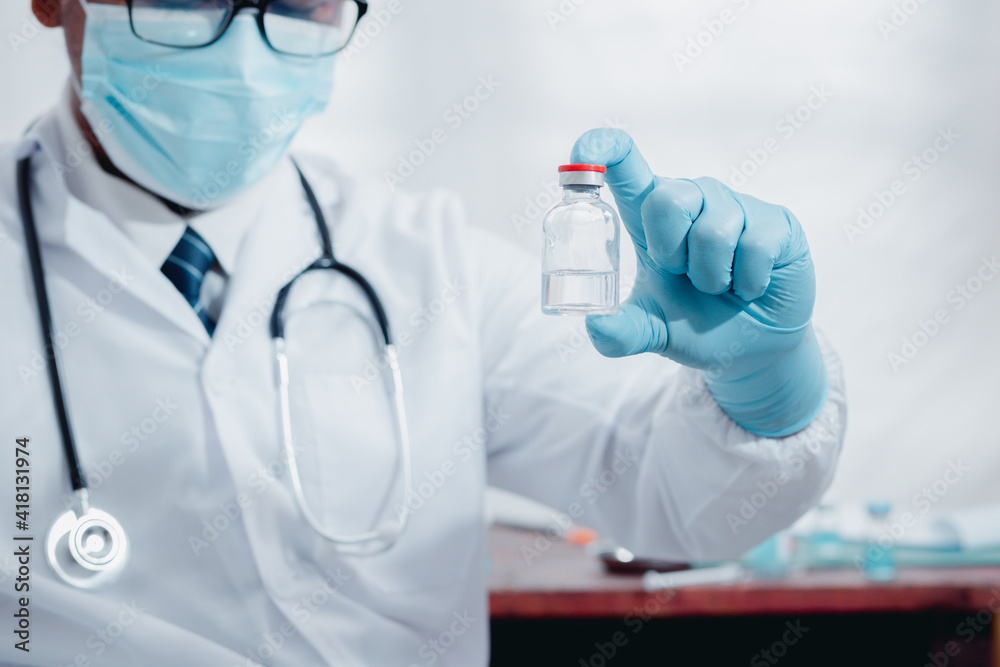 A doctor or laboratory scientist holds a syringe with a vaccine against the COVID 19 for new patients. Concept of protection against new virus strains
A doctor or laboratory scientist holds a syringe with a vaccine against the COVID 19 for new patients. Concept of protection against new virus strains