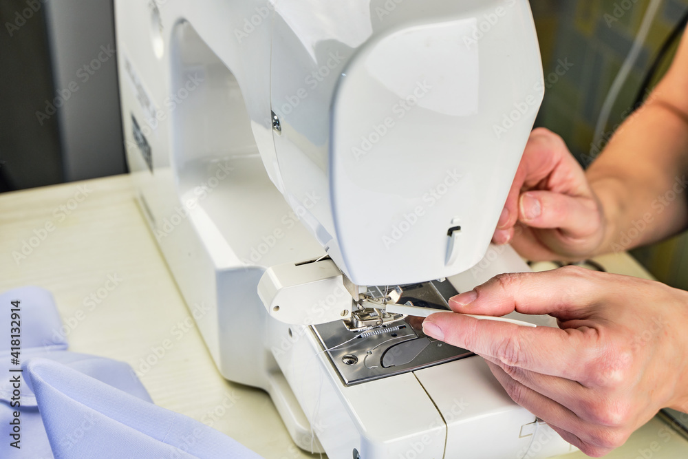 Female hands doing maintenance work on a domestic sewing machine