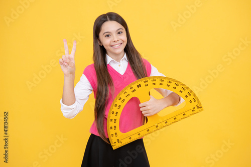 cheerful teen girl study math with protractor measuring size, back to school photo