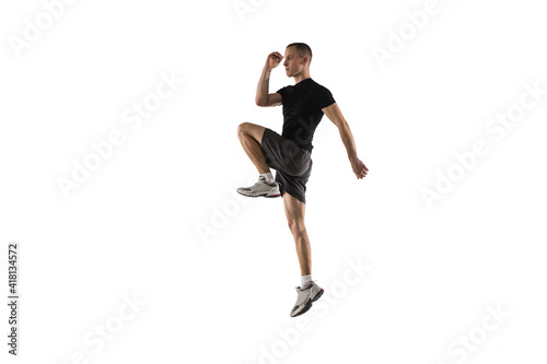 Fototapeta Naklejka Na Ścianę i Meble -  Running. Young caucasian male model in action, motion isolated on white background with copyspace. Concept of sport, movement, energy and dynamic, healthy lifestyle. Training, practicing. Authentic.