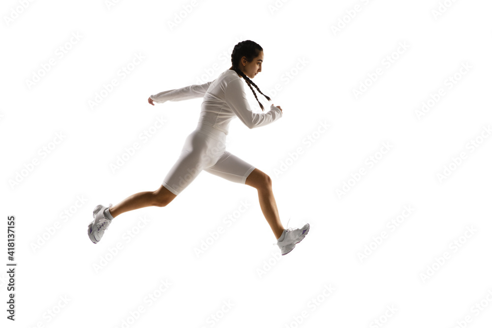 Running. Young caucasian female model in action, motion isolated on white background with copyspace. Concept of sport, movement, energy and dynamic, healthy lifestyle. Training, practicing.