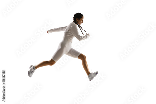 Running. Young caucasian female model in action, motion isolated on white background with copyspace. Concept of sport, movement, energy and dynamic, healthy lifestyle. Training, practicing. © master1305