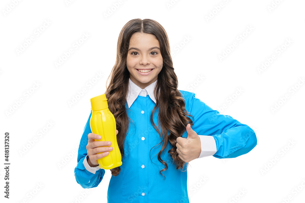 Happy kid give thumbs up hand gesture holding yellow plastic drinking bottle, approval