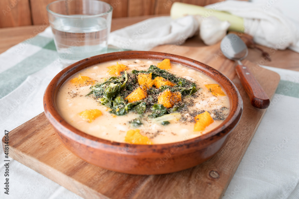 White bean dish with pumpkin, chard and crushed hemp seeds. Vegetable protein plate. Winter food photography