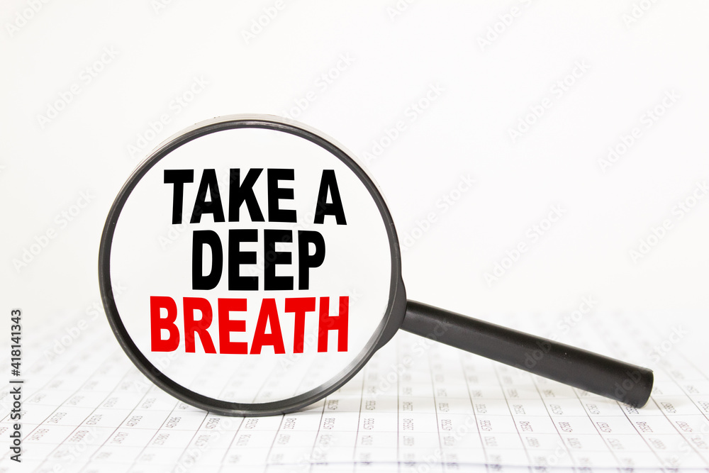 words TAKE A DEEP BREATH in a magnifying glass on a white background. business concept words TAKE A DEEP BREATH in a magnifying glass on a white background. business concept