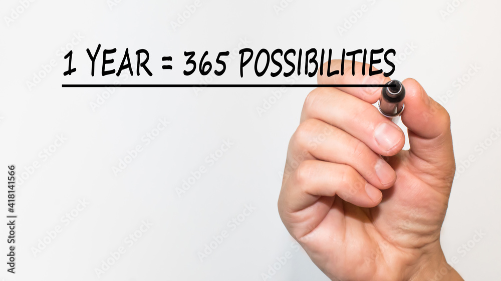 the hand writes text 1 YEAR 365 POSSIBILITIES with a marker on a white background. business concept the hand writes text 1 YEAR 365 POSSIBILITIES with a marker on a white background. business concept